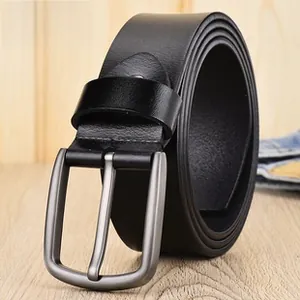 Detail of black woven elastic belt with silver matte buckle on wooden background