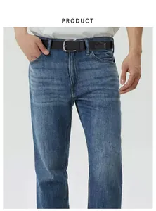 Detail of black elastic braided belt with silver pin buckle on blue denim jeans