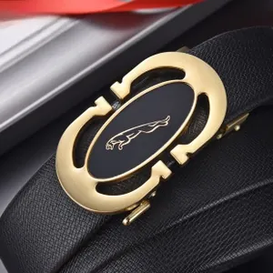 Close-up of golden automatic buckle with jaguar logo on black litchi leather belt