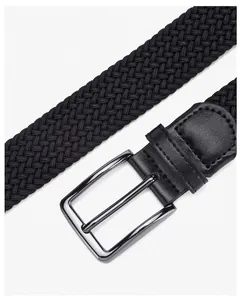 Close-up of black braided elastic belt with gunmetal needle buckle and leather trim