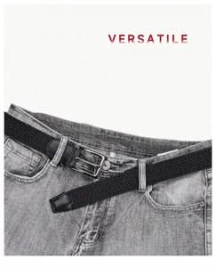 Close-up of black braided elastic belt with silver pin buckle on casual denim jeans