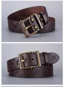 Macro shot of dark brown checkered embossed leather belt with retro brass pin buckle