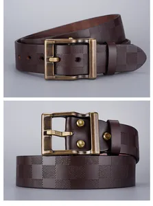 Macro detail of dark brown checkered embossed leather belt with vintage bronze pin buckle