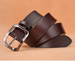 Macro detail of men's genuine leather belt with dark brown texture and silver buckle