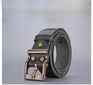 Close-up of vintage dark gray leather belt with brass buckle and metallic rivets