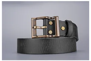 Close-up of vintage bronze buckle and textured black leather belt for men