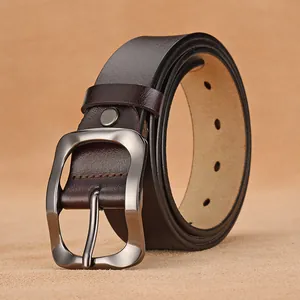 Men's vintage brown leather belt with matte gunmetal pin buckle on textured base