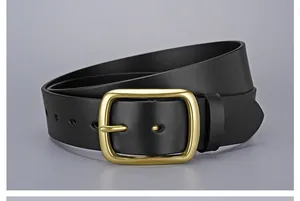 Close-up of matte gold buckle on a black premium cowhide leather belt for men