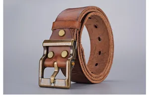 Detail of vintage brown leather belt showing rustic texture and brass pin buckle