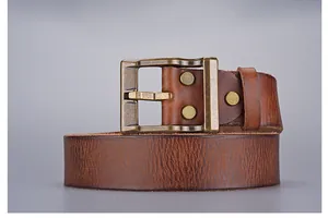 Close-up of vintage dark brown leather belt with antique bronze buckle and rivets