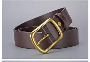 Detailed close-up of dark brown leather belt with vintage gold needle buckle
