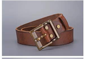 Detailed macro view of vintage dark brown leather belt texture and brass buckle with rivets