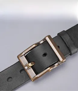 Macro shot of vintage brass buckle and high-quality black leather texture on men's belt