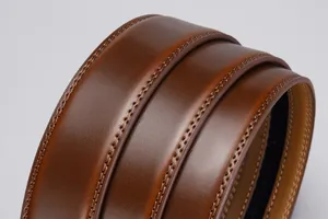 Detail of brown leather belt with reinforced double stitching and smooth polished finish
