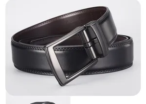 Detail of gunmetal rotating buckle on black and brown double-sided leather belt