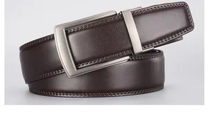 Close-up of brown lychee grain leather belt with brushed metal buckle and fine stitching