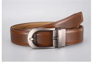 Detail of amber brown leather belt with double stitching and brushed metal buckle