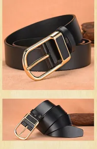 Close-up of premium black leather belt with golden metal buckle and textured finish