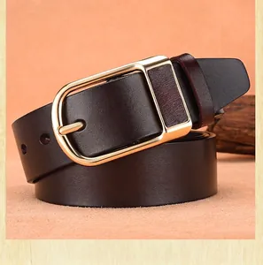 Detail of premium brown leather belt with a polished gold pin buckle for men
