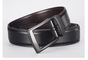 Close-up of reversible black and brown leather belt with matte gunmetal rectangular buckle