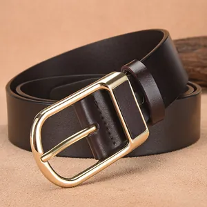 Premium men's leather belt with vintage gold buckle on a brown textured background