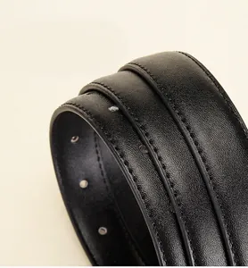 Macro detail of black genuine leather belt showing high-quality stitching and grain texture