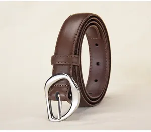 Detailed macro view of dark brown leather belt with irregular silver metal pin buckle