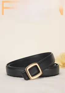 Detail of elegant black matte leather belt with gold square alloy buckle for women