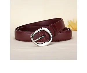 Detailed view of dark red leather belt with a polished silver oval metal buckle