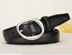 Detailed view of black leather belt featuring an irregular silver metal buckle on fabric