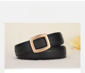 Detail of premium black leather belt showing matte gold buckle and fine stitching texture