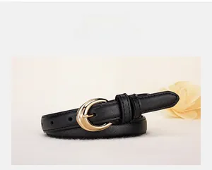 Detail of black leather belt with crescent gold buckle and fine lychee texture