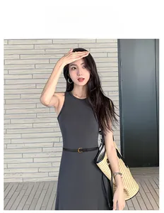 Detail of slim black leather belt with metal buckle on a grey sleeveless dress