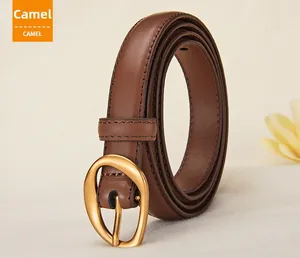 Close-up of camel leather belt with oval matte gold buckle and fine stitching