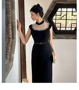 Close-up of a slim black leather belt with golden alloy buckle on a stylish qipao dress