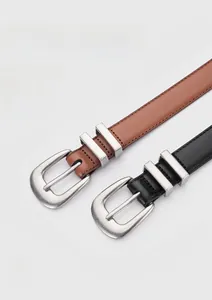 Detailed close-up of first layer cowhide leather belts with silver brushed metal buckles