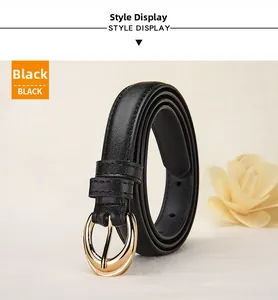Detail of slim black leather belt featuring a polished gold oval buckle with stitching