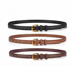 Detailed view of women's thin leather belts in black and brown with gold buckles