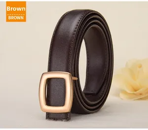 Macro shot of brown leather belt with textured litchi grain and matte gold pin buckle