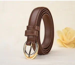 Detailed close-up of brown leather belt with gold oval pin buckle and fine stitching