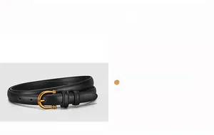 Close-up of black leather belt for women featuring a gold D-ring buckle and fine stitching