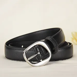Chic black leather belt for women featuring a polished silver oval buckle on beige background