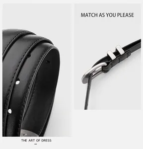 Detail of minimalist black leather belt featuring silver needle buckle and metal rings