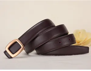 Detail of dark brown lychee grain leather belt with a golden square metal buckle