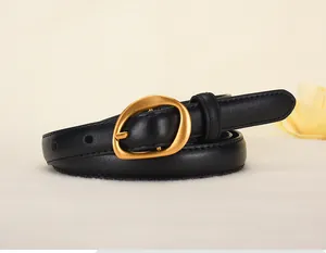 Detail of slim black leather belt featuring a modern irregular matte gold buckle design