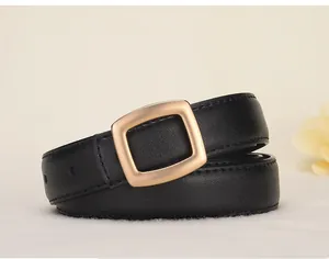 Close-up of black leather belt with fine texture and matte gold square pin buckle