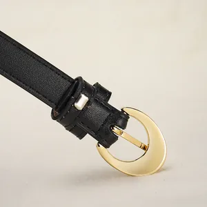 Women's black leather belt featuring a crescent moon gold buckle on textured litchi grain