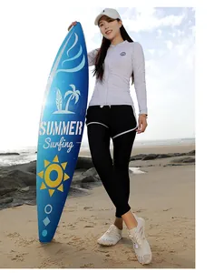 Detail view of long-sleeve zipper rash guard and black leggings with white side stripes