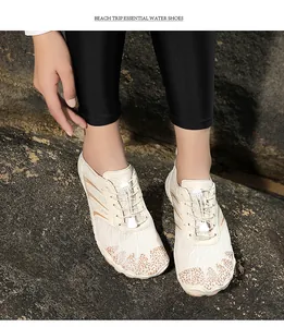 Close-up of cream quick-dry water shoes with breathable mesh and quick-lace system