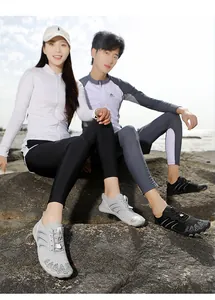 Detail of outdoor hiking shoes with breathable mesh and anti-collision toe on beach rocks